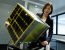 Astroscale Japan Inc President Miki Ito poses with a model of the company