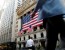 People sit outside the New York Stock Exchange (NYSE) during the morning commute in New York City, U.S., September 15, 2016.  REUTERS/Brendan McDermid - RTSNWHN